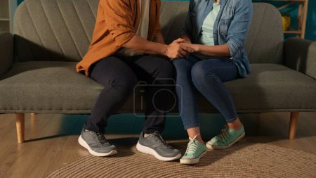 Photo for Man and woman, sitting on a couch, holding hands, close up, giving psychological support to each other. Marriage therapy, psychiatry, support, unity, concept of reconciliation - Royalty Free Image