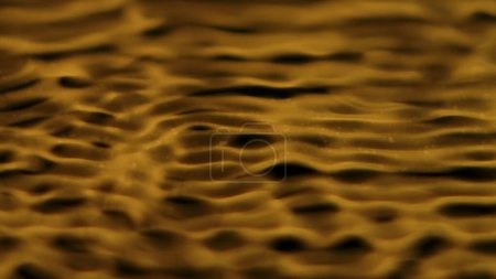 Photo for Water and liquids creative abstract advertisement concept. Close up shot of surface texture. Beautiful golden colored water surface with ripples and waves, abstract background, wallpaper template. - Royalty Free Image