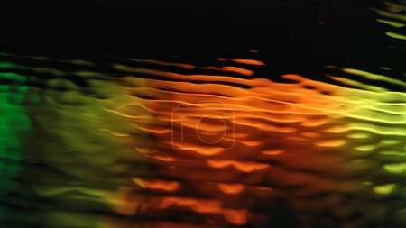 Foto de Agua y luz creativa concepto de publicidad abstracta. Primer plano de textura superficial. Hermosa superficie de agua de luz de neón vívida con círculos y ondas, fondo abstracto, plantilla de papel pintado. - Imagen libre de derechos