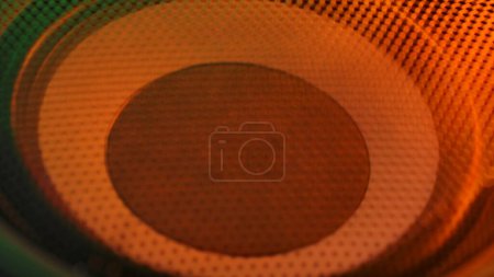 Photo for Music and sound technology creative abstract concept. Close up studio shot of speaker. Subwoofer with membrane orange neon light moving vibrating, macro sound bass circles, abstract background. - Royalty Free Image