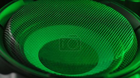 Photo for Music and sound technology creative abstract concept. Close up studio shot of speaker. Subwoofer with membrane green neon light moving vibrating, macro sound bass circles, abstract background. - Royalty Free Image