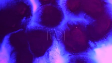 Photo for Water and liquid mixing creative abstract concept. Close up studio shot of aqua surface. Neon purple colored water with ink drops mixing in creating beautiful texture, abstract background wallpaper. - Royalty Free Image