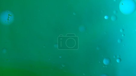 Photo for Water and liquid mixing creative abstract concept. Close up studio shot of aqua surface. Deep green colorful water with ink and oil drops matte beautiful texture, abstract background wallpaper. - Royalty Free Image