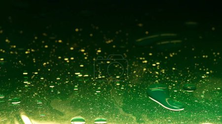 Photo for Water and different liquid creative advertisement concept. Close up studio shot of water texture. Green blurred ink colored water surface with oil drops on it mixing in, abstract wallpaper background. - Royalty Free Image