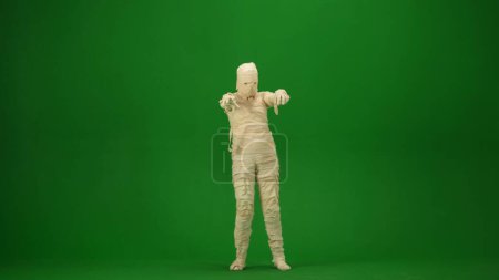 Photo for Green screen isolated chroma key photo capturing a mummy outstretching its arms and as if its trying to scare. Full length. Mock up, workspace for your promotion clip or advertisement. - Royalty Free Image