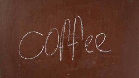 Photo for Textured brown chalkboard background. Coffee is written on the board with a piece of white chalk. Close up shot. Educational and creative content, food and drink concept. - Royalty Free Image