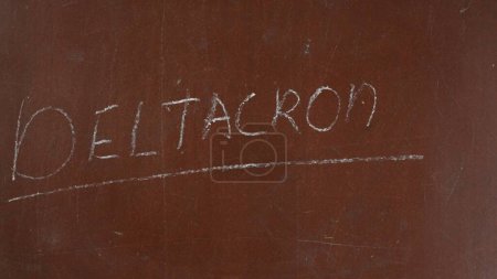 Photo for Textured brown chalkboard background. Deltacron is written on the board with a piece of purple chalk. Close up shot. Educational and creative content, healthcare concept. - Royalty Free Image