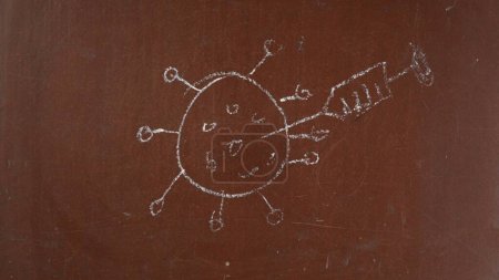 Photo for Textured brown chalkboard background. Sketchy virus cell killed by a syringe with vaccine is drawn on the board with a piece of chalk. Close up. Educational and creative content, healthcare concept. - Royalty Free Image