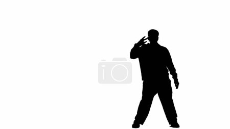 Téléchargez les photos : Encadré sur un fond blanc en silhouette. Un danseur masculin est représenté, seul son contour est visible. Démontre un mouvement de danse, montre un geste de la main. Il est plastique, rythmique. Cadre moyen - en image libre de droit