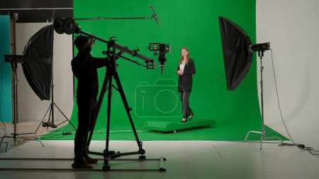 News anchor at work, woman journalist presenter telling breaking news, view of a backstage studio TV news shooting, chroma key template