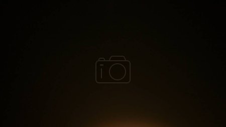 Photo for The frame shows an abstract on a black background, isolated. One edge of the frame is illuminated by fire, light. Creating a smooth transition, a gradient. Used for screensavers, backgrounds. Macro. - Royalty Free Image