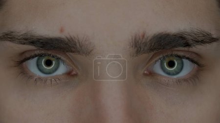 Photo for Eyes of a young man macro shot. Enlarged pupils, due to prolonged use of gadgets. Dry eye syndrome. Health concept - Royalty Free Image