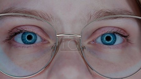 Photo for Eyes of a woman wearing glasses macro shot. Vision correction. Poor eyesight - Royalty Free Image