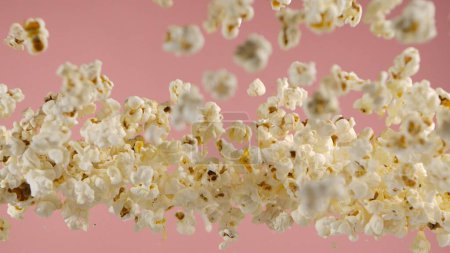 Photo for Falling popcorn, isolated on pink background - Royalty Free Image