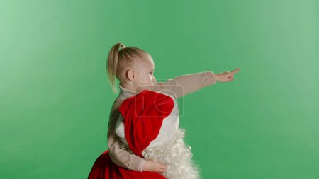 Photo for Merry Christmas and happy holidays Cute little child girl and Santa Claus looking at Christmas star. Christmas legend concept. - Royalty Free Image