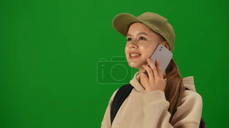 Photo for Airport creative advertisement concept. Portrait of person tourist isolated on chroma key green screen background. Close up shot young woman talking on smartphone looking at the departure board. - Royalty Free Image