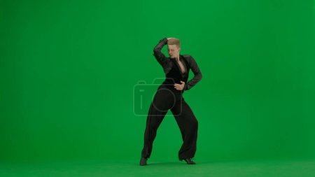 Photo for An elegant ballroom dance duo performs a dynamic routine captured against a vivid green screen background. This image is perfect for projects that require chroma key compositing, offering a versatile - Royalty Free Image