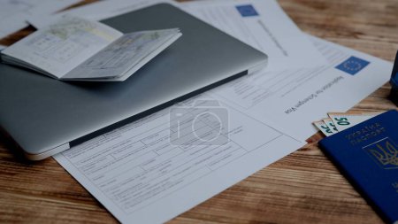 Photo for Passport and migration creative advertising concept. Close up of an identity document. A Ukrainian passport with euro money, documents and a stamp is lying on the table - Royalty Free Image