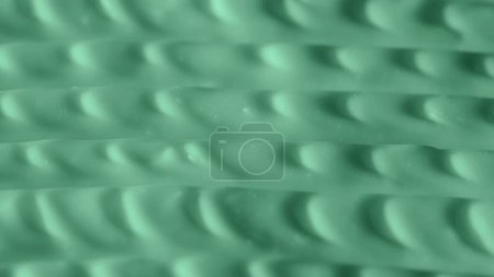 Photo for Beauty and skin care products advertisement creative concept. Close up shot of cream background. Face or body smooth green cream fluid texture with strokes and lines. - Royalty Free Image
