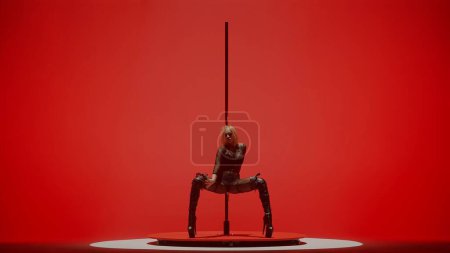 Photo for Modern dance style and choreography creative concept. Portrait of young female dancer in the studio. Professional pole dancer girl dancing on pylon, showing modern pole dance, red neon background. - Royalty Free Image