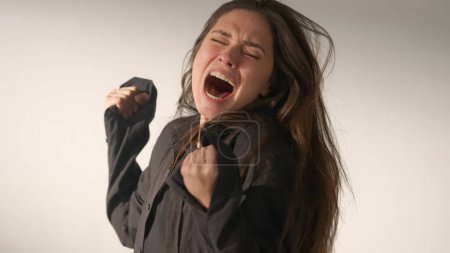 Photo for Human extreme emotions creative advertisement concept. Portrait of attractive female model in negative mood. Studio shot of brunette woman in hysterical mood, screaming yelling in anger and sorrow. - Royalty Free Image