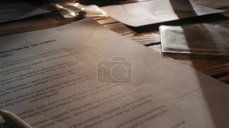 Photo for Criminology and forensic creative advertisement concept. Close up shot of investigation board. Detective desk with blank of interrogation of female activist laying on it, light at the background. - Royalty Free Image
