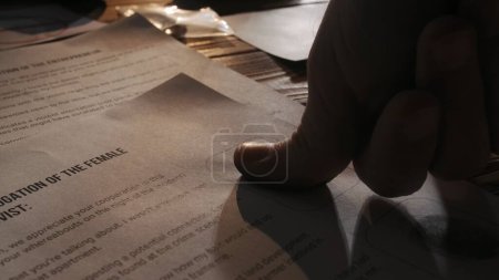 Photo for Criminology and forensic creative advertisement concept. Close up shot of investigation board. Detective desk with blank of interrogation of female activist man leaving his fingerprints on the paper. - Royalty Free Image