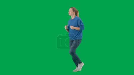 Photo for Woman in casual clothes running on green screen. Advertising, promo, chroma key - Royalty Free Image