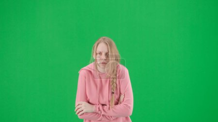 Photo for Robbery and criminal concept. Portrait of victim on chroma key green screen background. Young girl walking, scared expression. - Royalty Free Image