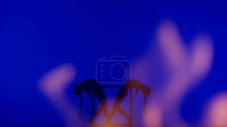 Foto de Coreografía moderna y acrobacia concepto de publicidad creativa. Silueta de dos acróbatas hembras aisladas sobre fondo de neón azul con llamas. Chicas bailarinas gimnásticas ejecutando elemento en cubo. - Imagen libre de derechos