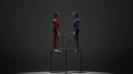 Photo for Modern choreography and acrobatics creative advertisement concept. Portrait of two female acrobats isolated on black background. Girls aerial dancers in blue red suits performing element on a cube. - Royalty Free Image