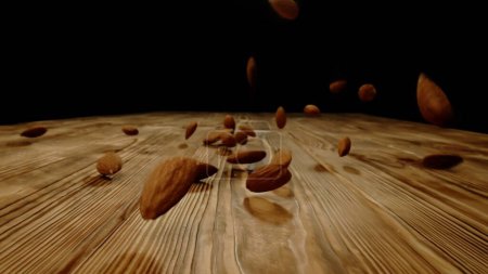 Photo for Nuts and spices creative advertisement concept. Close up studio shot of food ingredients on the wooden table. Many roasted and unpeeled almonds falling on the rustic wooden surface. - Royalty Free Image