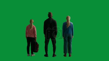 Photo for Back view of a team of three hikers looking out and admiring the view. A group of people in a studio on a green screen. Travel concept - Royalty Free Image