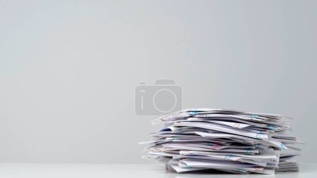 Photo for Workplace paperwork routine creative advertisement concept. Time lapse of paper sheets on white background. Stop motion animation of pile business paper documents files with clips at the table. - Royalty Free Image