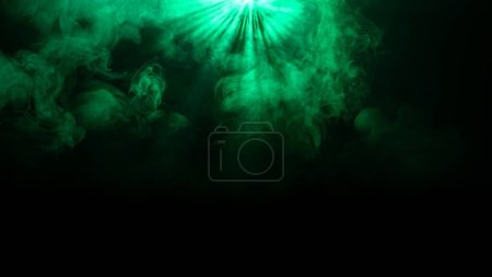 Photo for Professional stage equipment and lightning creative advertisement concept. Studio shot of projector haze isolated on black background. Green neon light rays shining from top with smoke moving on set. - Royalty Free Image