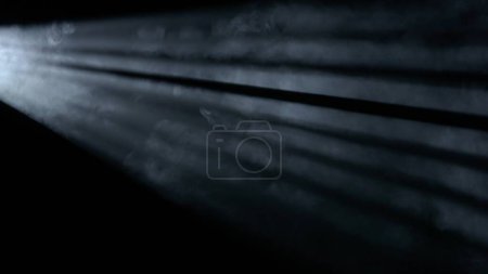 Photo for Professional stage equipment and lightning creative advertisement concept. Studio shot of projector haze jalousie effect isolated on black background. White bright rays shining from side with smoke. - Royalty Free Image