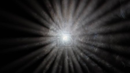 Photo for Professional stage equipment and lightning creative advertisement concept. Studio shot of projector haze isolated on black background. Close up of white light rays shining in center with smoke motion. - Royalty Free Image