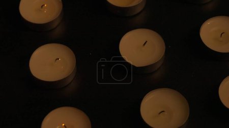Photo for Rows of candles. The candles are extinguished and the remnants of the flame are visible on the wick. The concept of a memorial day in a temple or church Background for advertising and design projects. - Royalty Free Image