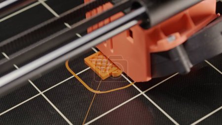 Photo for The process of printing a part on a 3D printer, close-up. Watch as our printer brings each tiny part to life, printing it layer by layer and accurately recreating a given part model - Royalty Free Image
