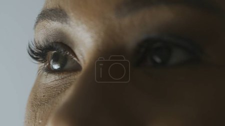 Photo for Eyesight care treatment ophthalmological services concept. Macro shot of female model face. African American woman shot cropped face, green eyes looking away from camera. - Royalty Free Image