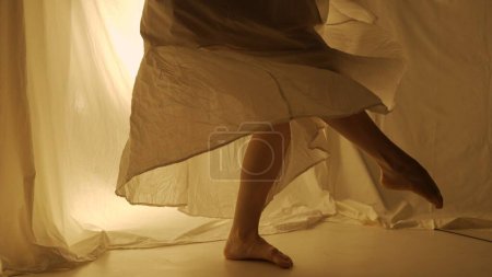 Photo for Silhouette contemporary experimental choreography concept. Female dancer performing in the studio. Young girl dancing against warm back light. - Royalty Free Image