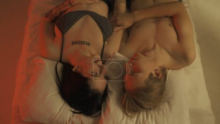 Photo for Love intimate relationships concept. Top view loving couple romantic time in bedroom. Man and woman sensual lovers laying in bed together, laughing talking and smiling, intimacy bonding. - Royalty Free Image