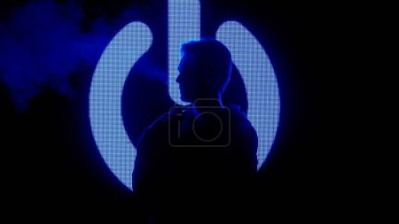 Photo for Digital visual technology concept. Male against big digital wall. Man silhouette smoking electronic cigarette in front of digital screen wall with neon symbols in dark club. - Royalty Free Image