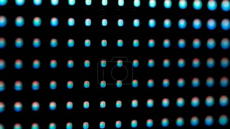 A macro shot of a digital LED panel. The image highlights the individual RGB pixels arranged in a grid. Screen blinking and epileptic glitches.