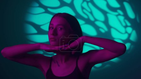 Photo for Dive into the essence of hip-hop where a girls fluid dance moves come alive under a kaleidoscope of vibrant spotlight effects. Each step and spin tells a story of rhythm and street dance culture - Royalty Free Image