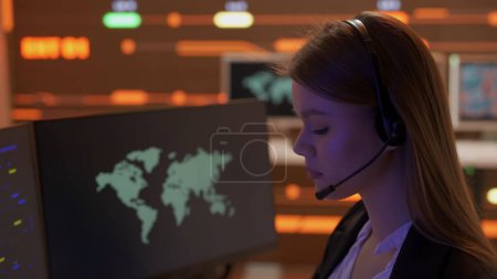 Photo for Project manager computer science concept. Technical support in control room. Female IT specialists in headsets work on computers, big digital screen infrastructure monitoring infographic network data. - Royalty Free Image