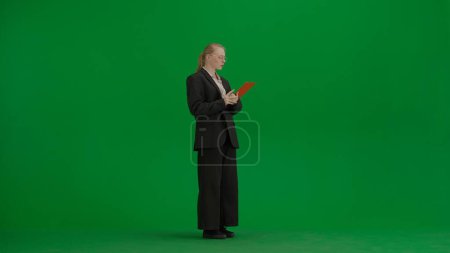 Photo for Modern businesswoman creative advertising concept. Women in business suit on green screen with chroma key. Blonde business woman with red folder in hands. - Royalty Free Image