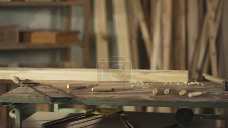 Photo for Carpentry and handicraft advertisement concept. Cinematic shot of table with tools in the garage. Professional carpenter tools, equipment and wooden materials laying on the table in workshop. - Royalty Free Image