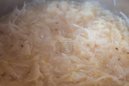 Close-up of sauerkraut with cumin in a pot.