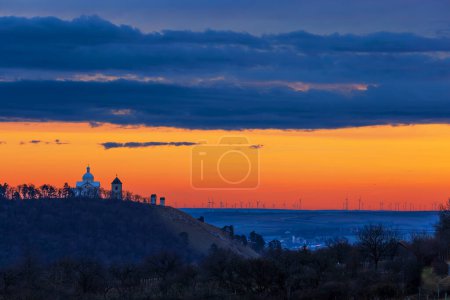 Photo for Vineyards in South Moravia near Mikulov in the Czech Republic. In the background is the Holy Hill and the sky at the setting sun - Royalty Free Image